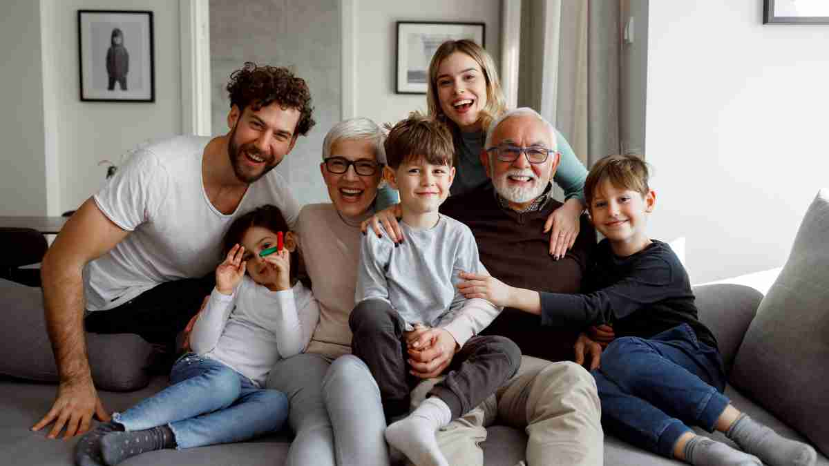 A family with different generations sitting on a couch representing a family trust for wealth transfer.